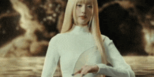 a woman with long blonde hair is wearing a white shirt