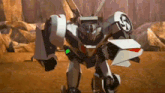 a robot that looks like a car is standing on a dirt field .