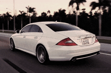 a white mercedes with a florida license plate that says pb02