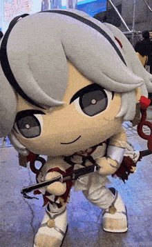 a stuffed animal with a sword and a rose in her hand