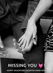 a black and white photo of a couple holding hands .