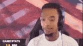 a man wearing headphones is looking at the camera .
