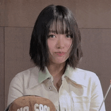 a woman wearing a white shirt and a brown hat that says no cool