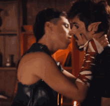 a couple of men are kissing and one of them has elf ears on his face
