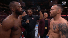 two men are standing in front of a referee wearing a ufc shirt