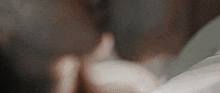 a close up of a person holding a cup of coffee in their hands .
