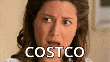 a woman with a surprised look on her face has costco written on the bottom