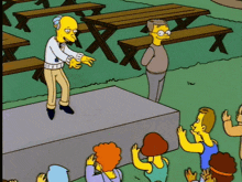 a cartoon of a man standing on a stage with a crowd watching