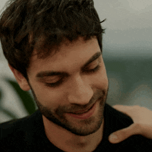 a close up of a man 's face with a beard