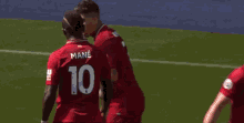 a soccer player in a red jersey is giving the middle finger .