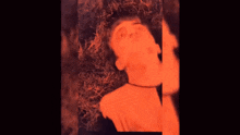 a close up of a man 's face with an orange glow