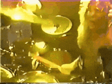 a painting of a person playing drums with the letters i and j visible