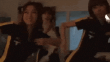 a group of people are dancing together in a dark room .