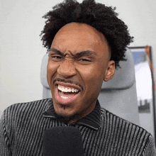 a man with a striped shirt is making a funny face