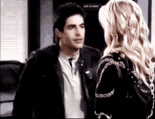 a man and a woman are standing next to each other .