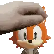 a person is petting a cartoon character 's head with their hand .