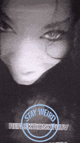 a black and white photo of a woman with the words stay weird reflection of uv below her