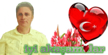 a man in a yellow shirt stands in front of a red heart and flowers with the words iyi aksamlar on the bottom