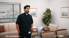 a man in a priest 's robe is standing in a waiting room with nbc written on the bottom