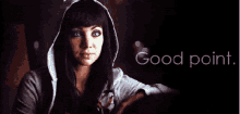 a woman in a hooded sweatshirt is holding a glass of wine and says good point