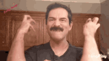 a man with a mustache is making a funny face in front of a sign that says baby bump