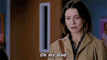 a woman in a tan coat is talking to another woman and says oh my god