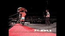two wrestlers in a ring with the letters rbu on the side