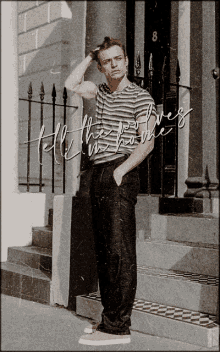 a man in a striped shirt stands in front of a door with the number 8 on it