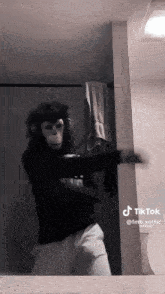 a person dressed as a monkey is dancing in front of a mirror