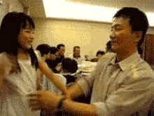 a man and a girl are dancing in a room