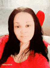 a woman wearing a red shirt with galaxy a34 sg below her