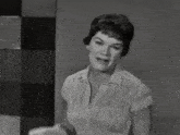 a black and white photo of a woman talking