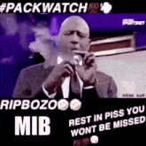 a man in a suit is singing into a microphone while smoking a cigar .