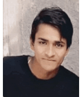 a young man wearing a black shirt is looking at the camera .
