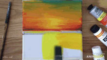 a painting is being made with a brush and a bottle of acrylic paint
