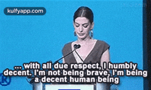 a woman is standing at a podium giving a speech and saying with all due respect