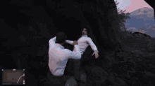 a man in a white shirt is standing in a dark cave