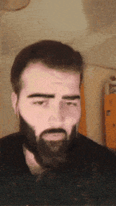 a man with a beard is making a face