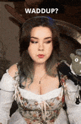 a woman wearing headphones and a corset is talking into a microphone with the word waddup written above her