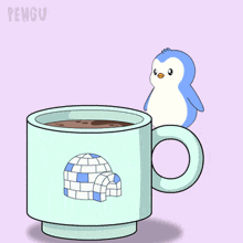 a cup with an igloo on it is filled with a brown liquid