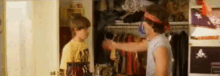 a couple of people are standing in a closet .