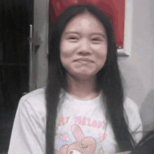 a woman wearing a white shirt that says melody on it