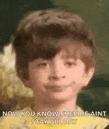 a young boy with a big haircut is smiling and says `` now you know sherrie ain t stay all day '' .
