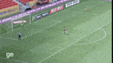 a soccer game is being played in a stadium with the word ge on the bottom right