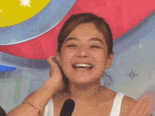 a woman wearing a white tank top with a sticker that says bianca