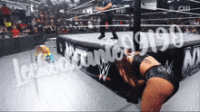 a woman in a wrestling ring with the number 9980 written on the side