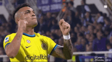 a soccer player wearing a yellow jersey that says digitalkits on it