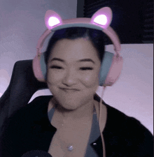 a woman wearing pink headphones with cat ears