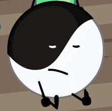 a cartoon drawing of a black and white yin yang symbol with a sad face