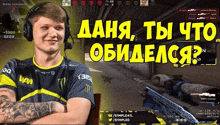 a man wearing headphones and a shirt that says navi stands in front of a computer screen
